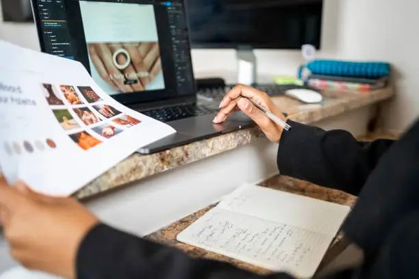 Close-up of a woman website developer designing a webpage on laptop at creative office Cropped shot of a female website developer holding product portfolio while designing a webpage on laptop at creative office website stock pictures, royalty-free photos & images
