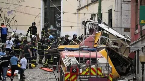 Reuters First responders work at the site of an accident involving Lisbon's Gloria funicular