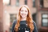 A person smiling at camera

Description automatically generated