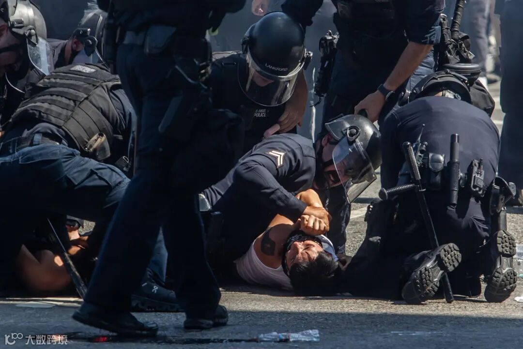 Los Angeles Police Department officers arrest a protester in front of the LA Federal Building on Sunday.