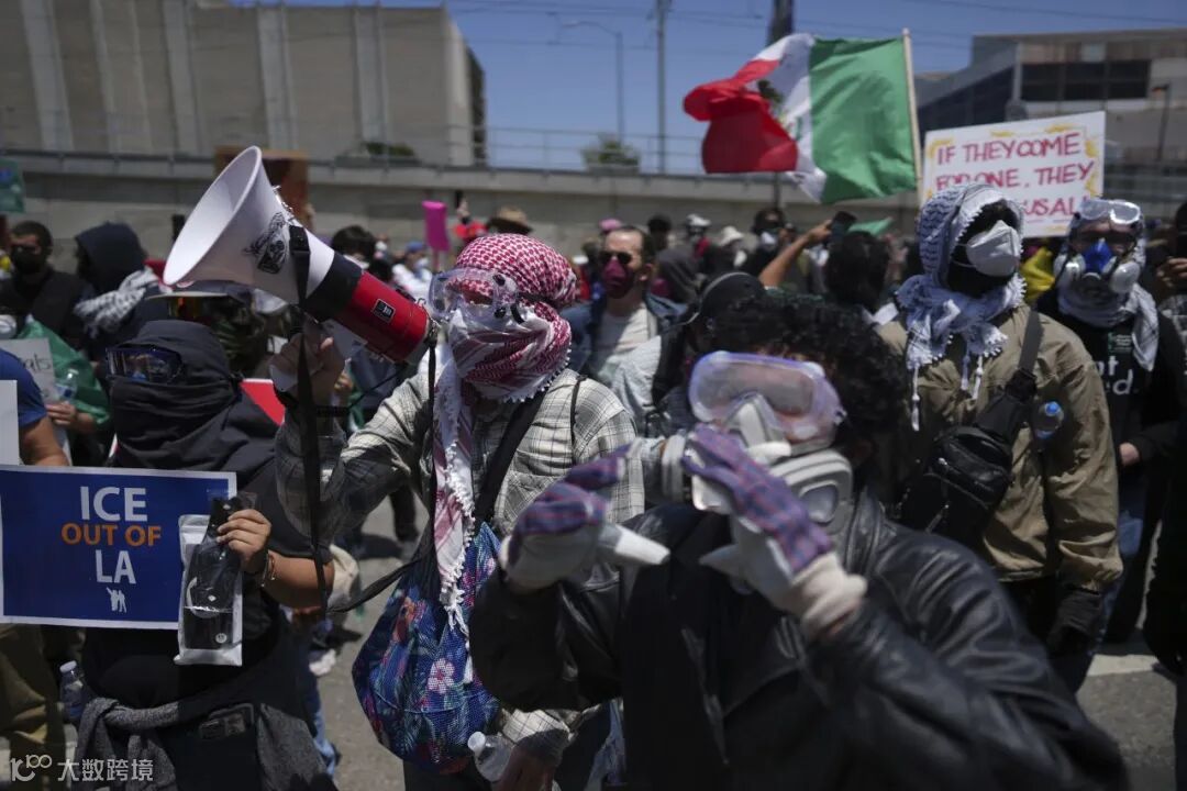 Protesters confront a line of National Guard troops.