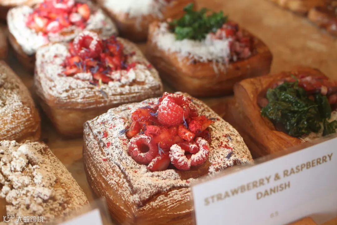 A display case filled with lots of different types of pastries