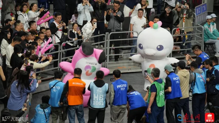 男篮决赛开始前，“大湾区顶流”献出倒立绝技，炒热赛场氛围。从内胆、表情包到周边，十五运会吉祥物火遍全网，特许商品销售额已达6.8亿元。