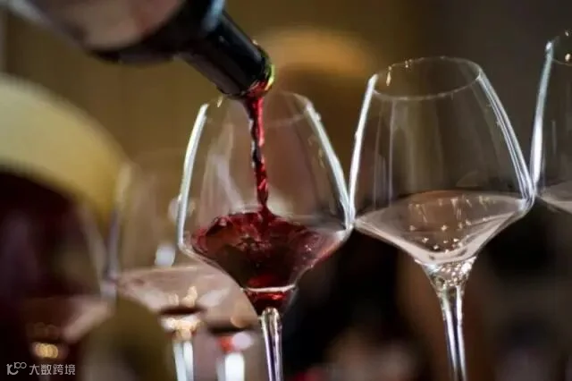 190281-a-waiter-serves-a-glass-of-red-wine-at-a-tasting-in-hong-kong-in-may-2.jpg
