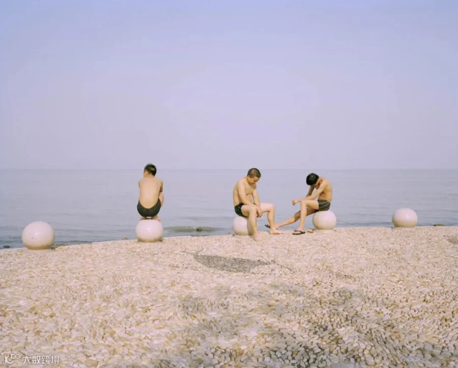 Three men sunbathe by Lake Tai in Wuxi, Jiangsu province, 2013. Courtesy of Chen Liang