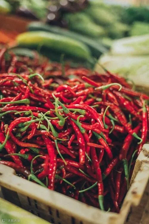 Free Vibrant red cayenne peppers displayed in a market. Fresh and spicy variety. Stock Photo