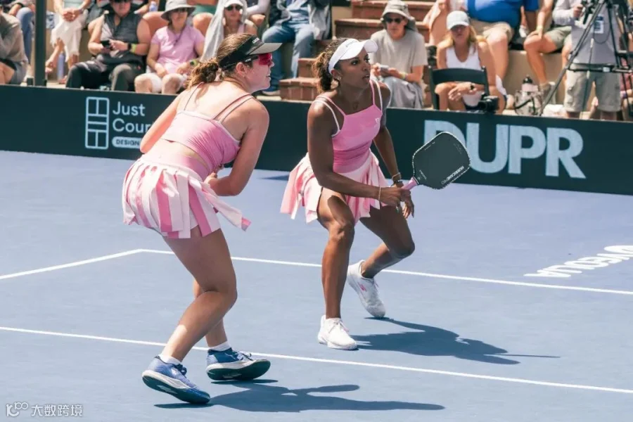 Johnson and Black wearing matching pink outfits