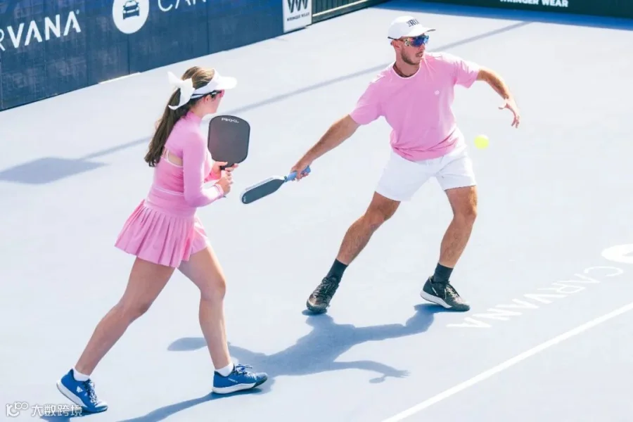 Johnsons wearing pink outfits on the pickleball court