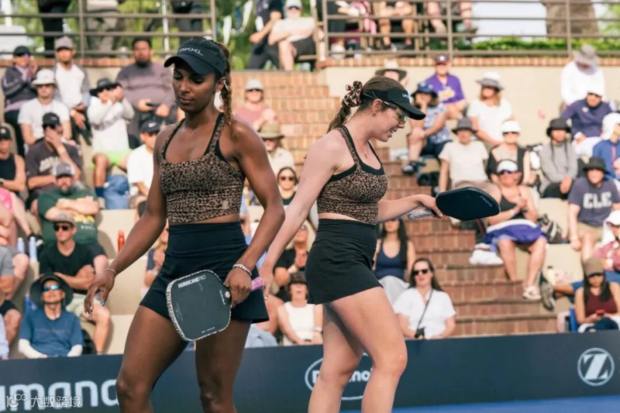 Black and Johnson in cheetah print tops and black skirts