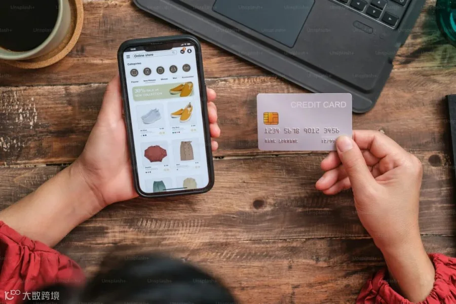 close up woman hand using credit card shopping online on mobile app on wood table at home